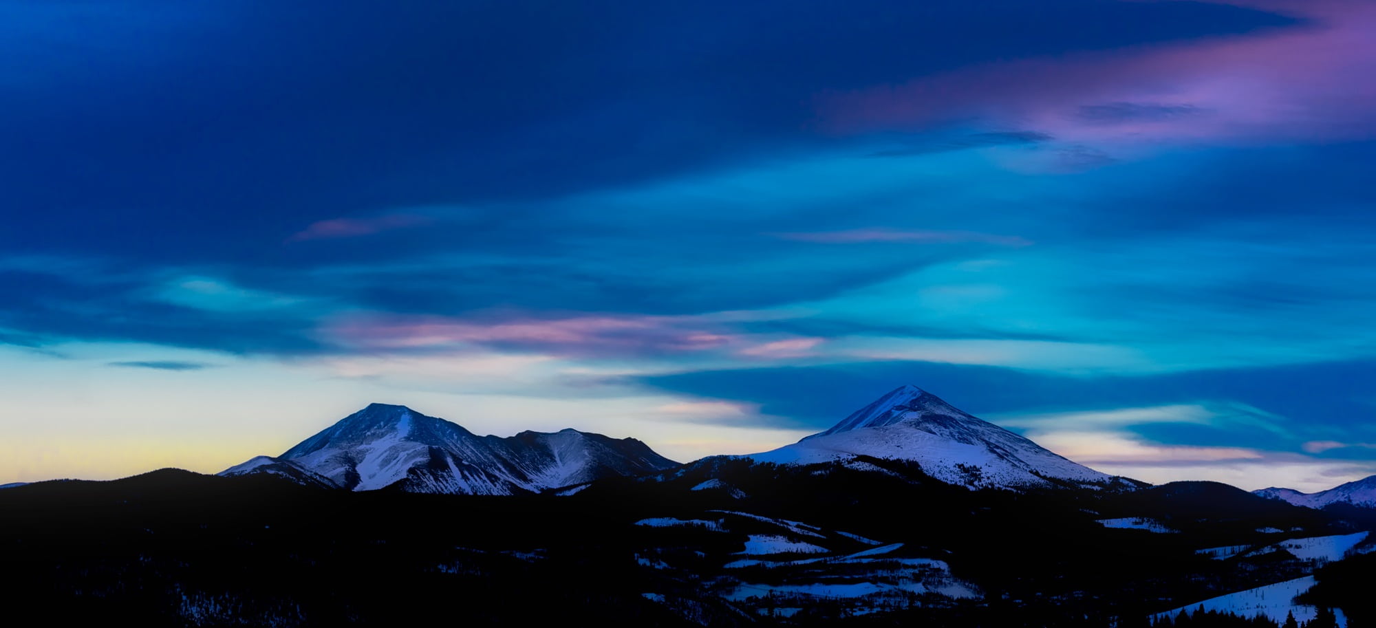 Snow-capped mountain range at blue hour